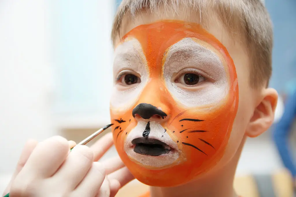 Child having a mask painted on face - symbol of high-functioning armor and burnout
